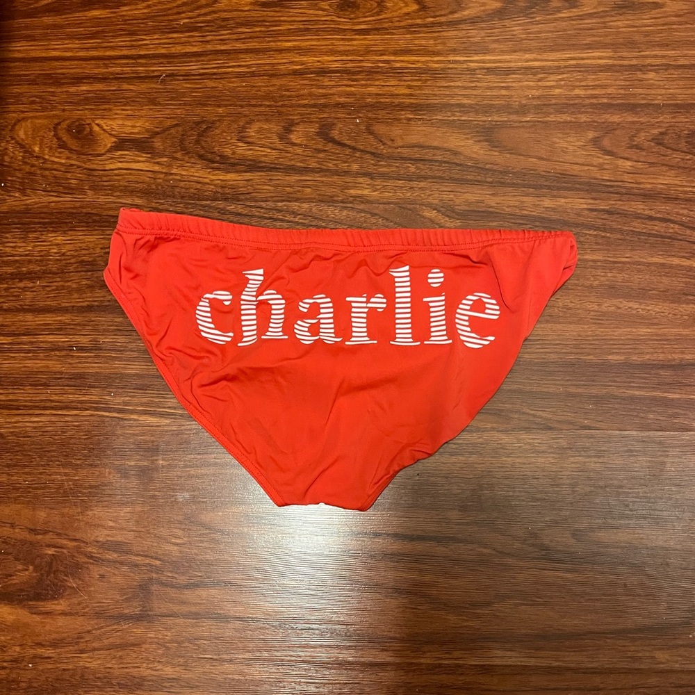 Charlie by Matthew Zink red speedo with logo.